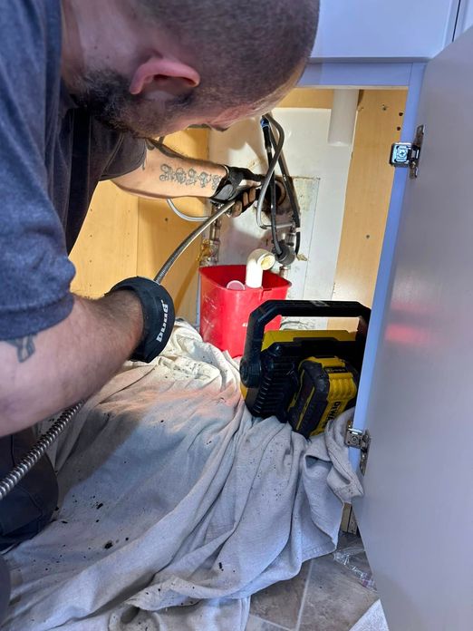 Plumber working on pipes